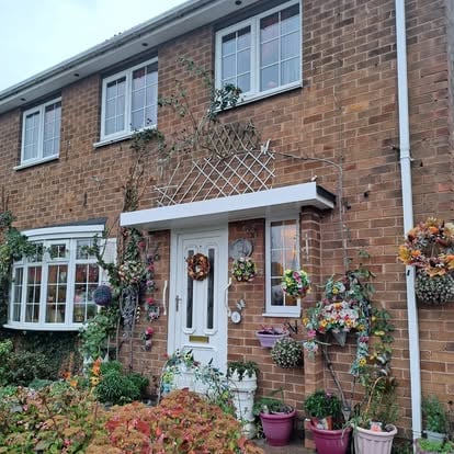 Brick house exterior with new white door canopy