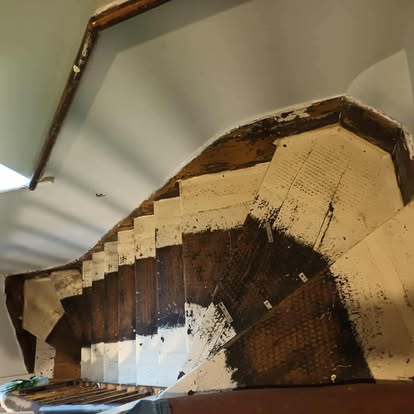 Curved staircase underside with new metal brackets