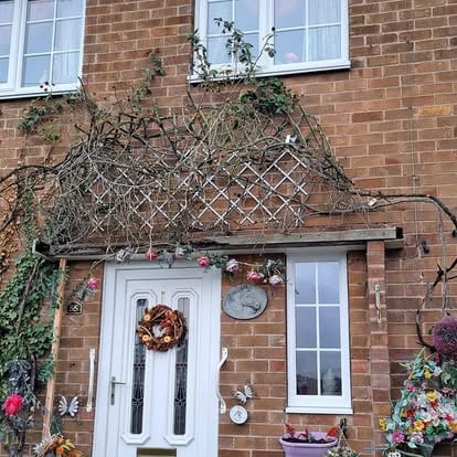 House before canopy work with overgrown trellis