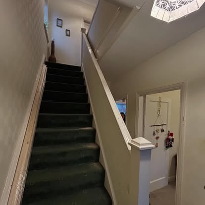 Staircase before renovation, old white balustrade