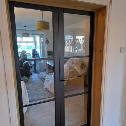 Black Crittall-style glazed French doors in doorway