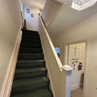 Staircase before renovation, old balustrade and carpet