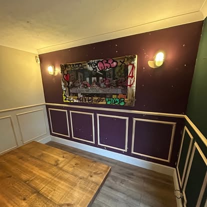 Purple dining room with white wall panel mouldings