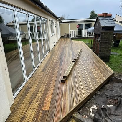New timber decking alongside bungalow with bifold doors