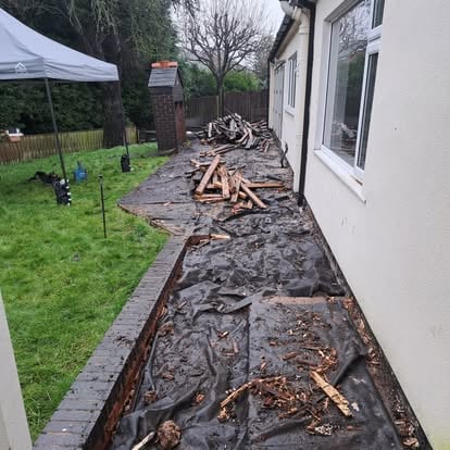 Old decking stripped, black membrane visible