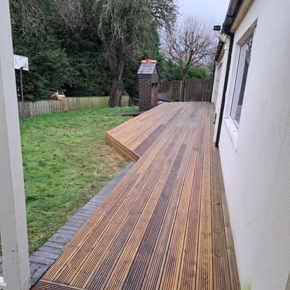 Completed timber decking alongside bungalow, wide view