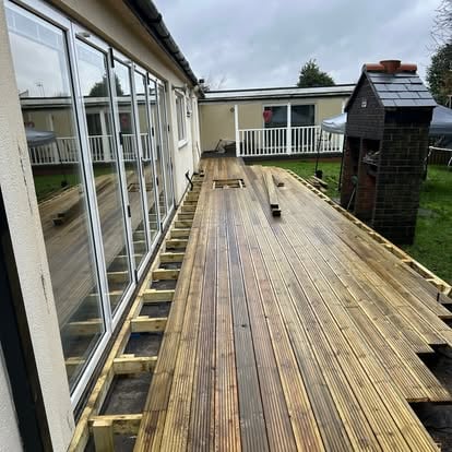 Decking partially boarded, edge joists still visible