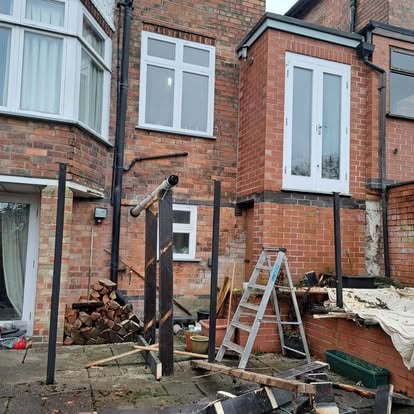 Steel posts and partial timber frame with patio below